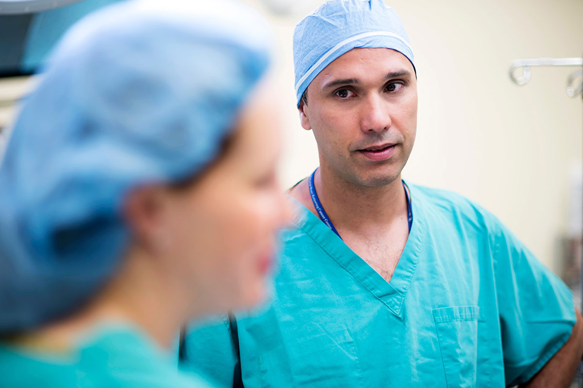 MSK surgeon, Oliver Zivanovic, speaking with a female colleague dressed in their scrubs.