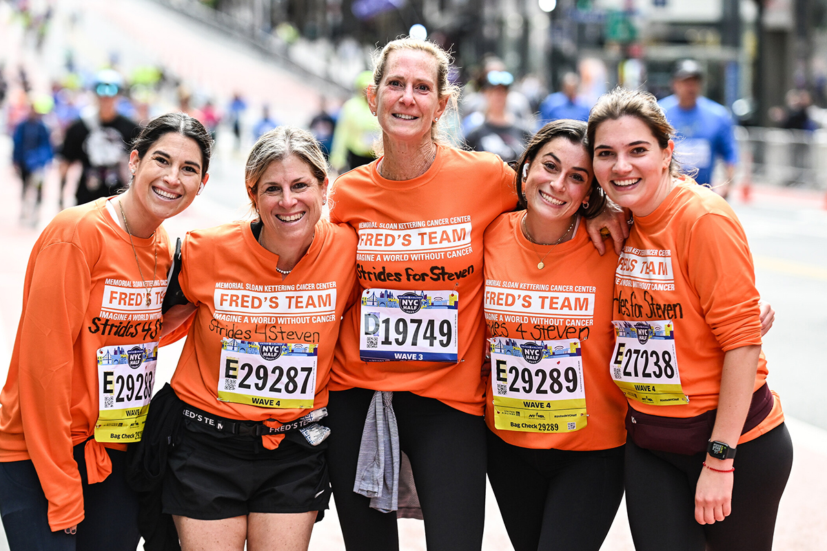 A group of smiling runners wearing Fred's Team T-shirts 