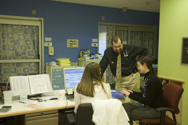 Farid Boulad, Medical Director of the Pediatric Day Hospital, consults with fellows in the Pediatric Observation Unit.