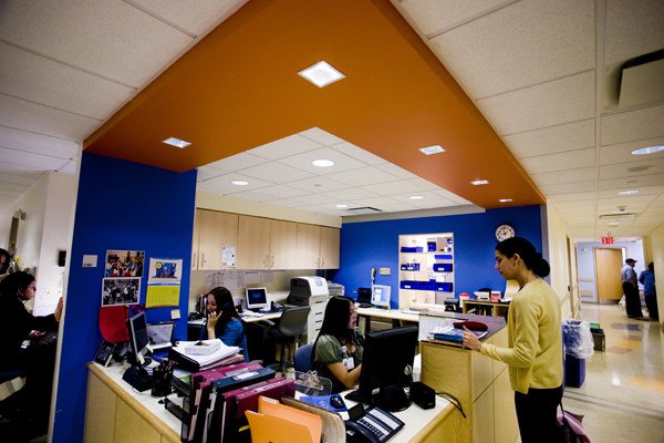 The exam reception area is a central hub for doctors, nurses, and administrative staff to coordinate appointments for patients.