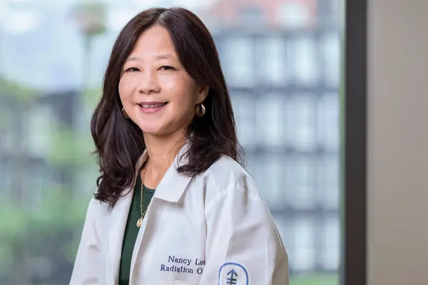 Radiation oncologist Dr. Nancy Lee, at MSK in New York City, in a white doctors’ coat. 