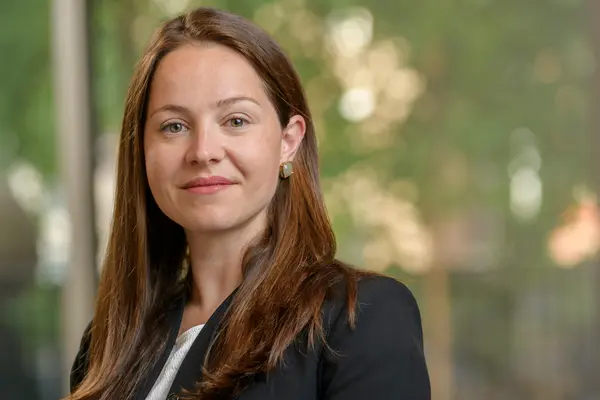 Colorectal surgeon Dr. Maria Widmar at MSK, standing with a window behind her. 