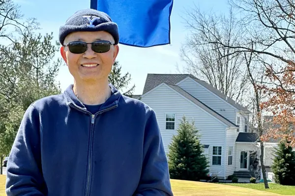 Prostate cancer survivor Dr. Shieh, outdoors at a golf course. 
