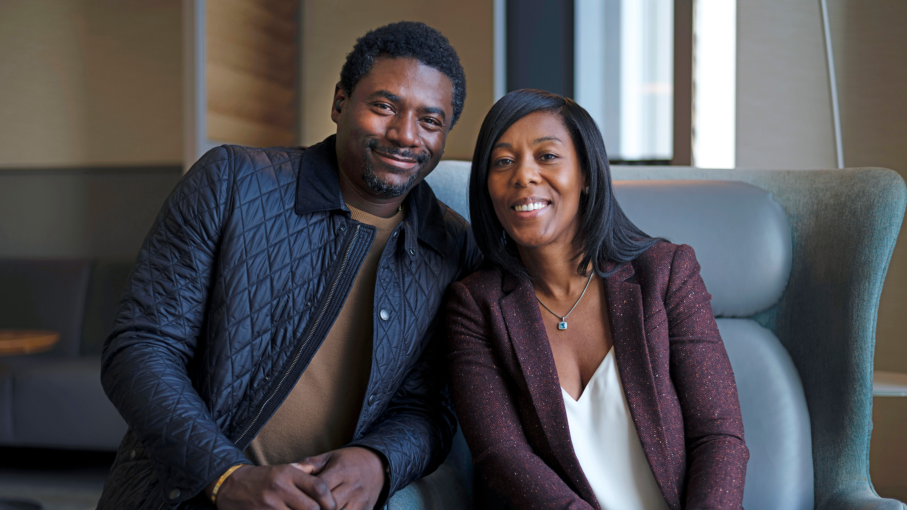Rectal cancer survivor Roxanne Joseph, sitting with her husband and smiling, had rectal cancer surgery at MSK.