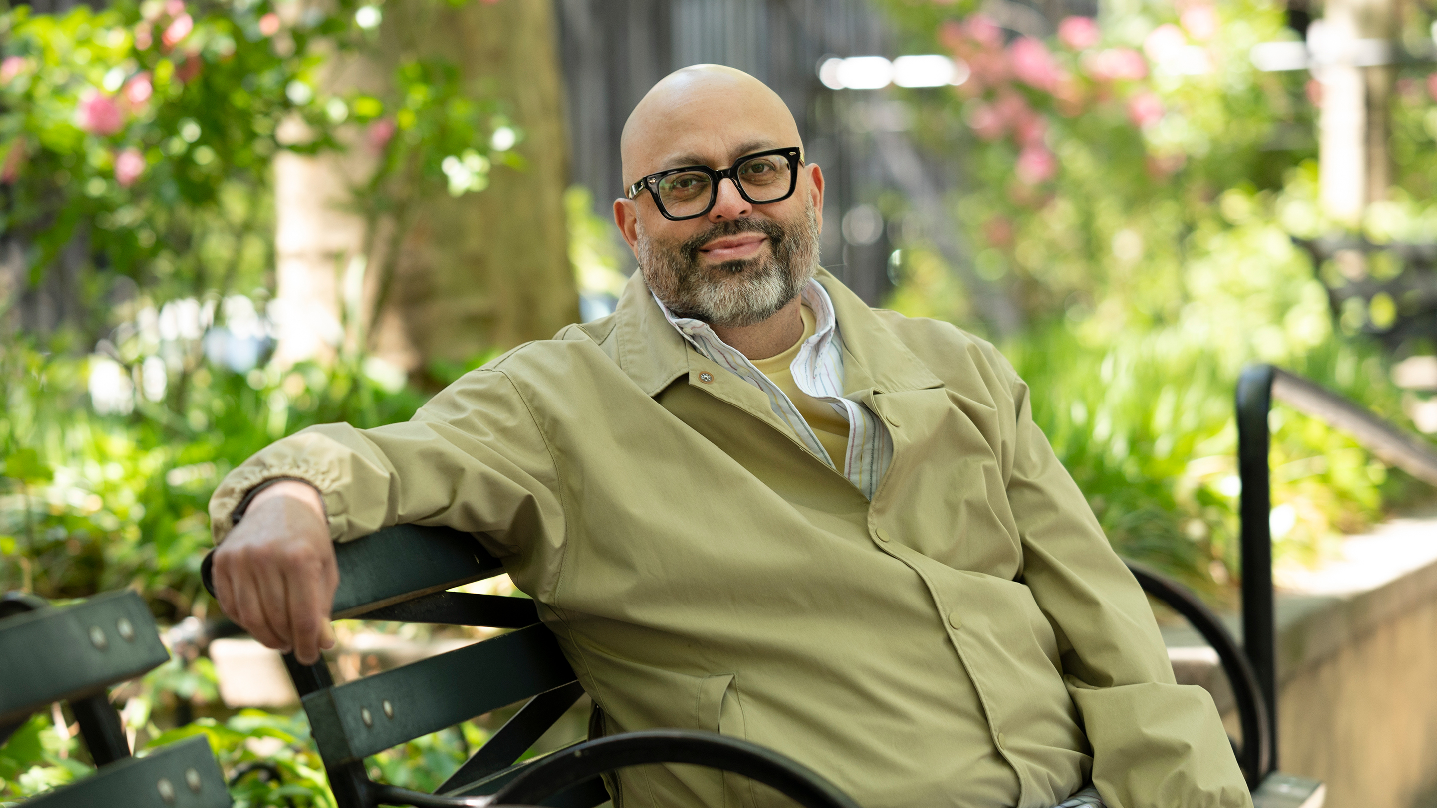 An MSK patient sitting in a relaxed pose on a park bench.