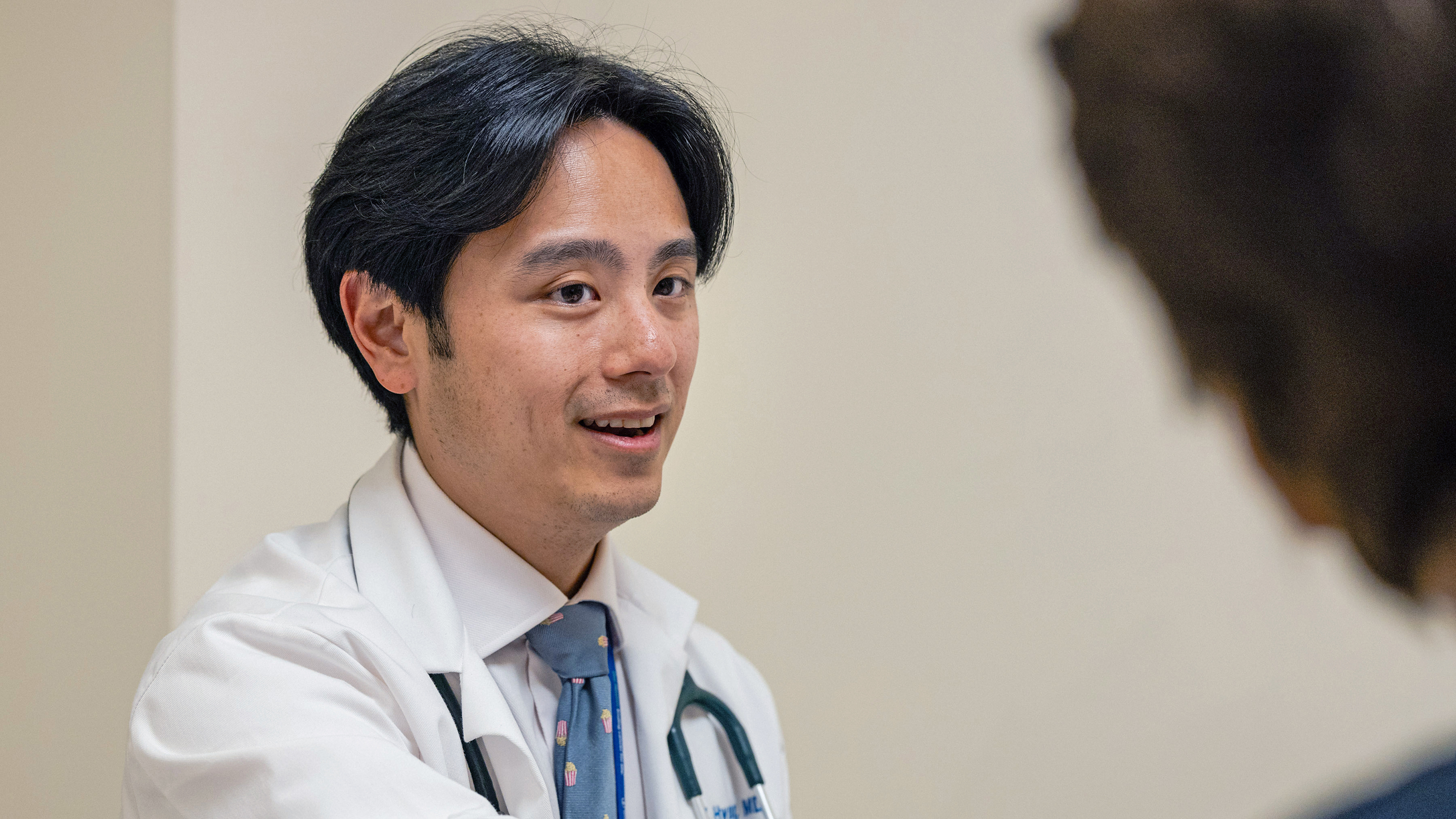 Head and neck medical oncologist Dr. Michael Hwang talks with his patient at MSK in Commack on Long Island. 