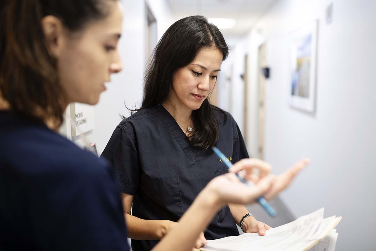 MSK mohs surgeon, Erica Lee, looks at paperwork with her colleague.