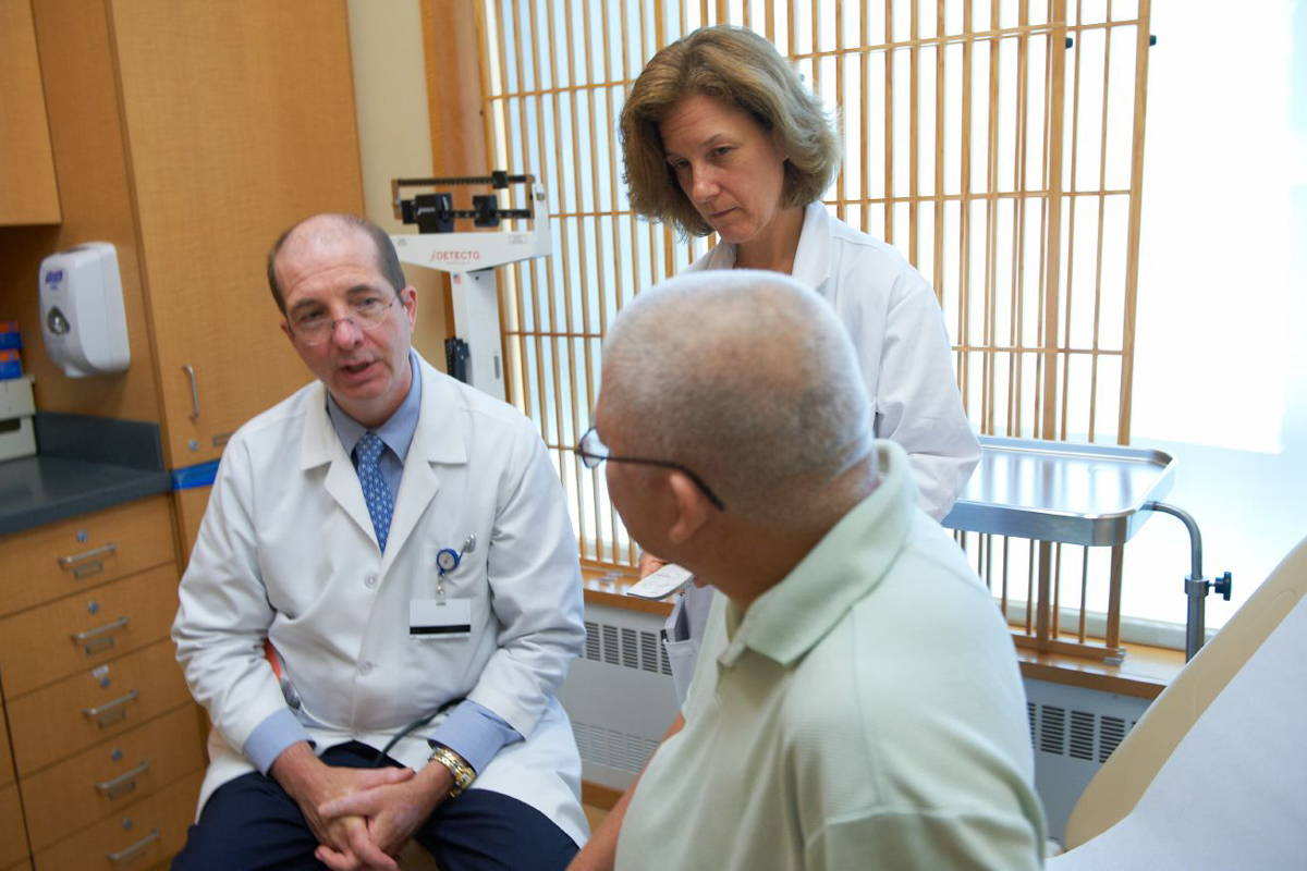 Dr. Motzer and his nurse, speak to a kidney cancer patient.