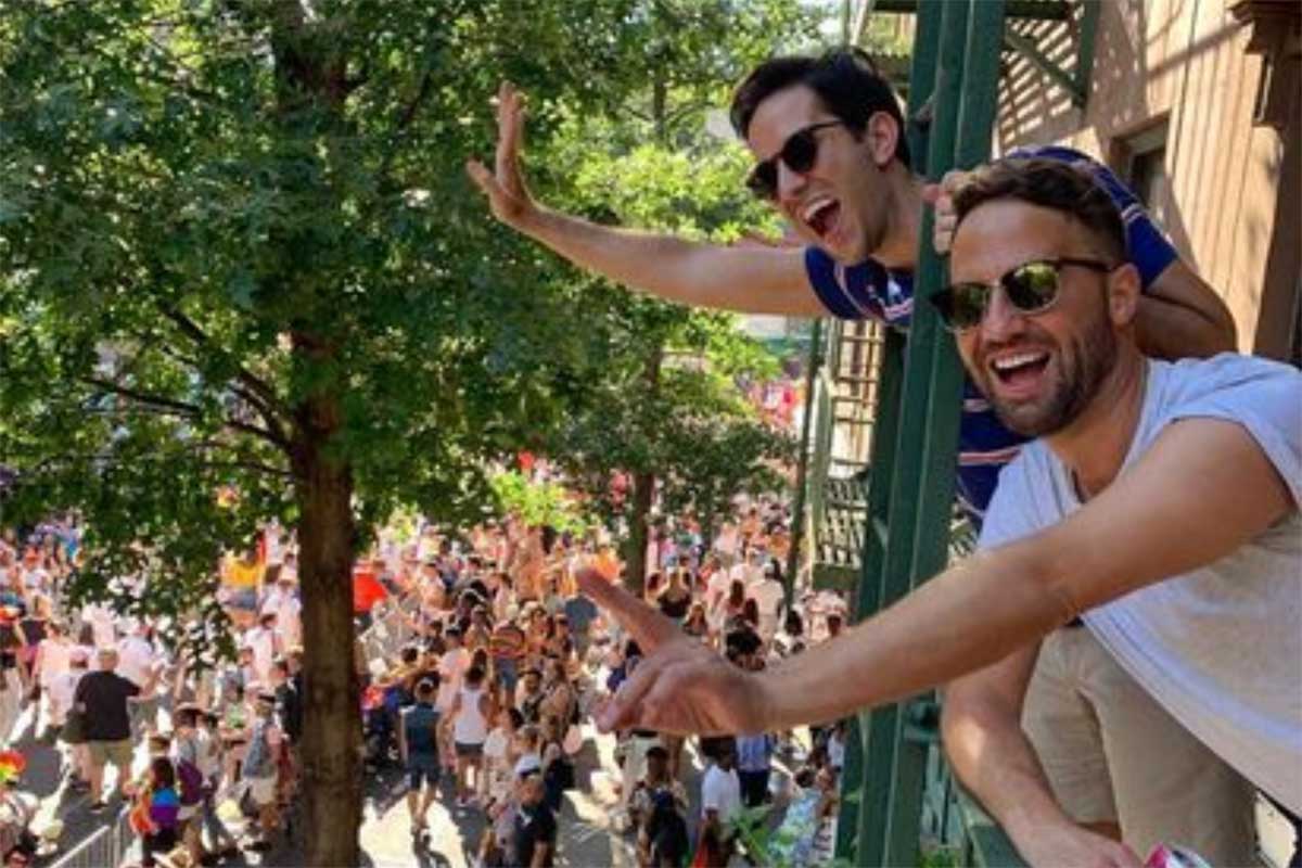 Anthony (front) and Bradley wave to passersby during a previous NYC Pride March