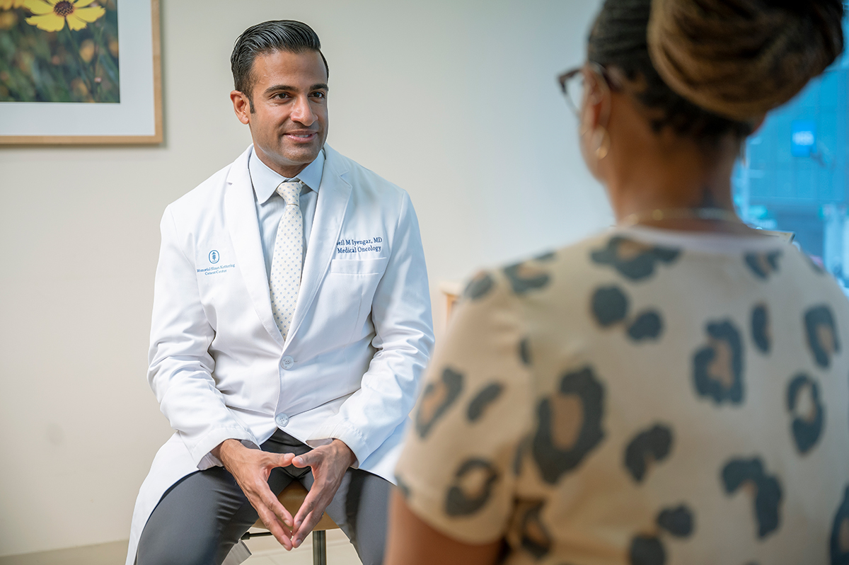 Breast cancer oncologist Neil Iyengar seen talking with patient