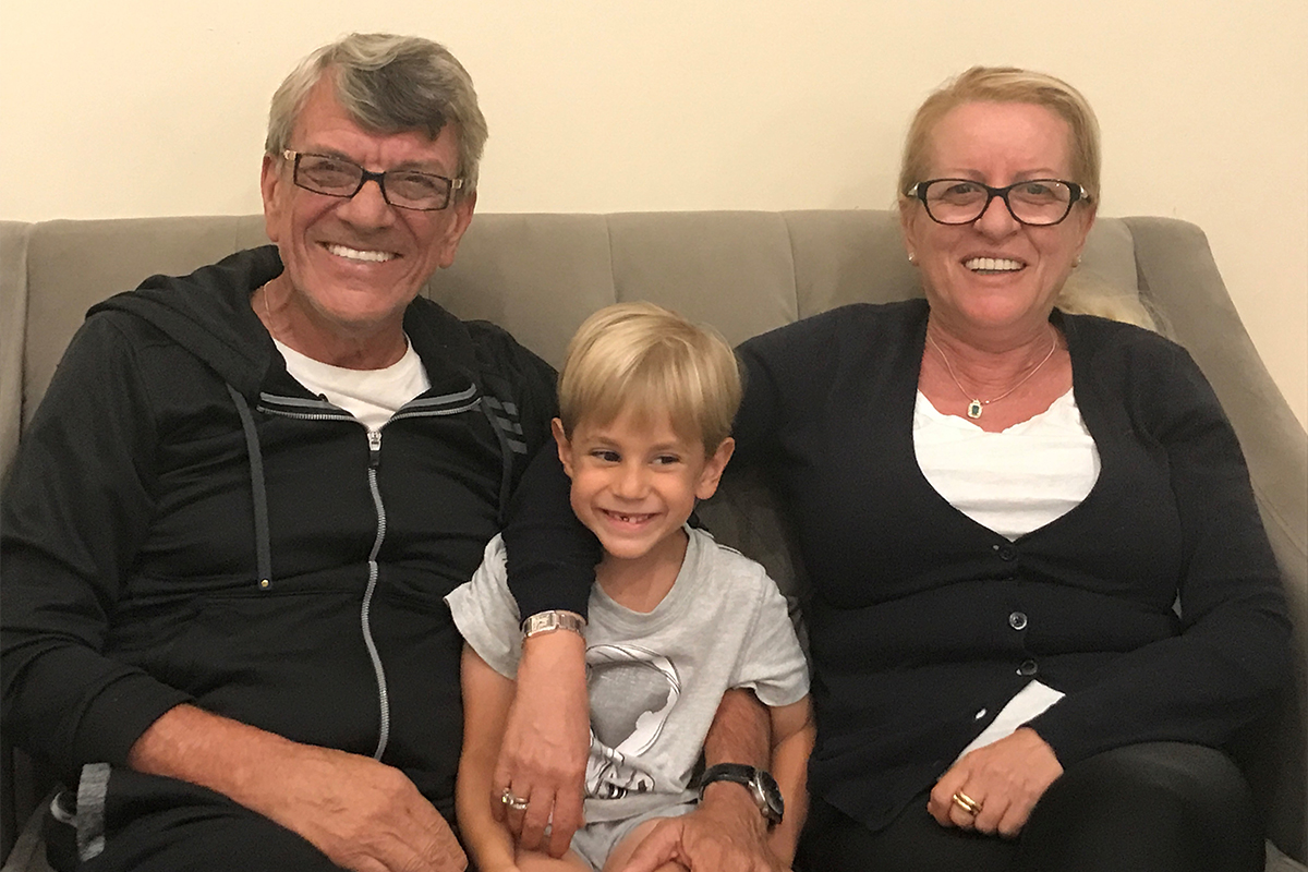 Grandmother and grandfather on couch with grandson
