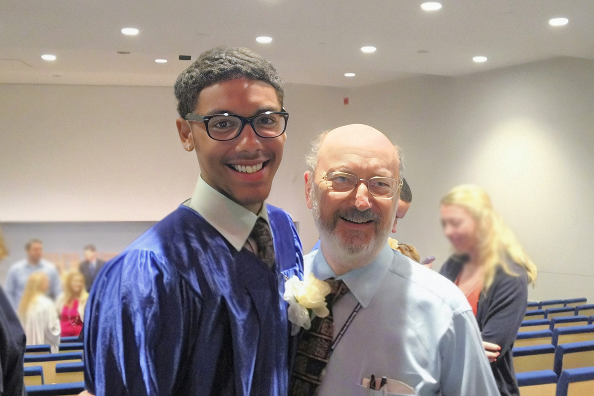Joshua at his high school graduation with his oncologist, Peter Steinherz, MD
