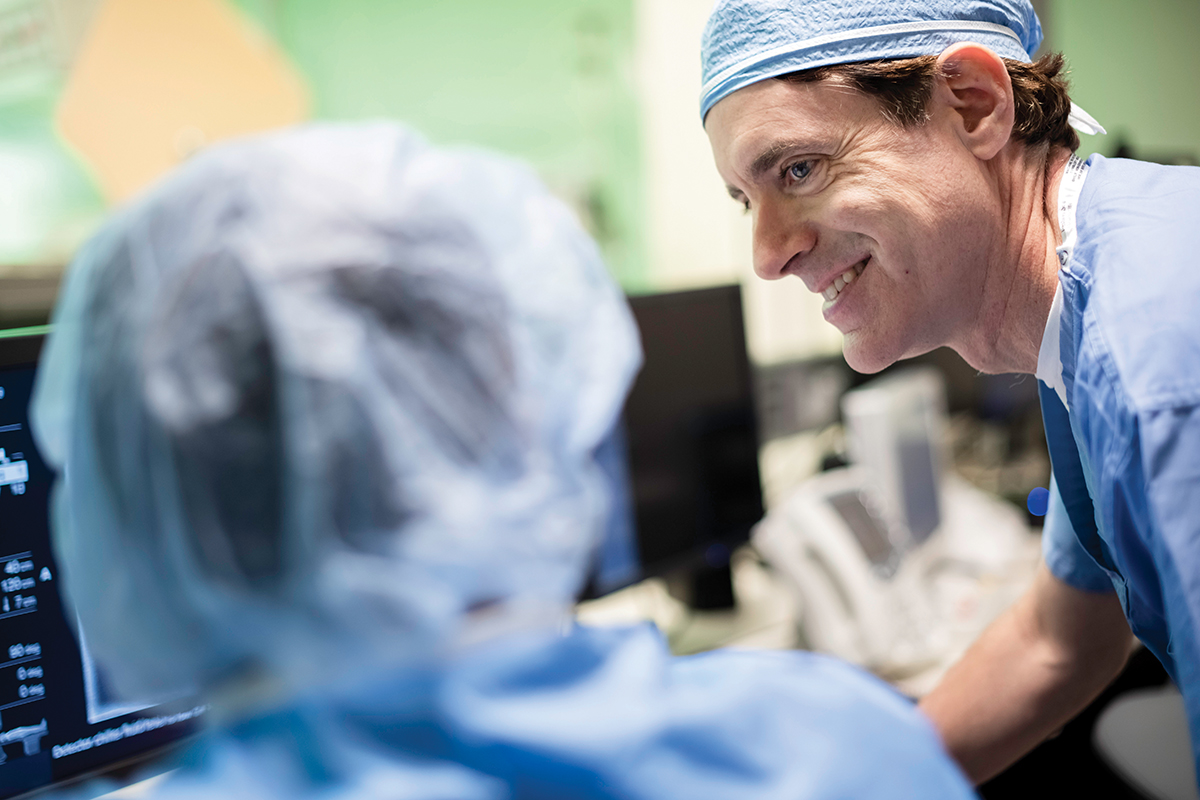 MSK interventional radiologist Stephen Solomon talks with colleagues. 