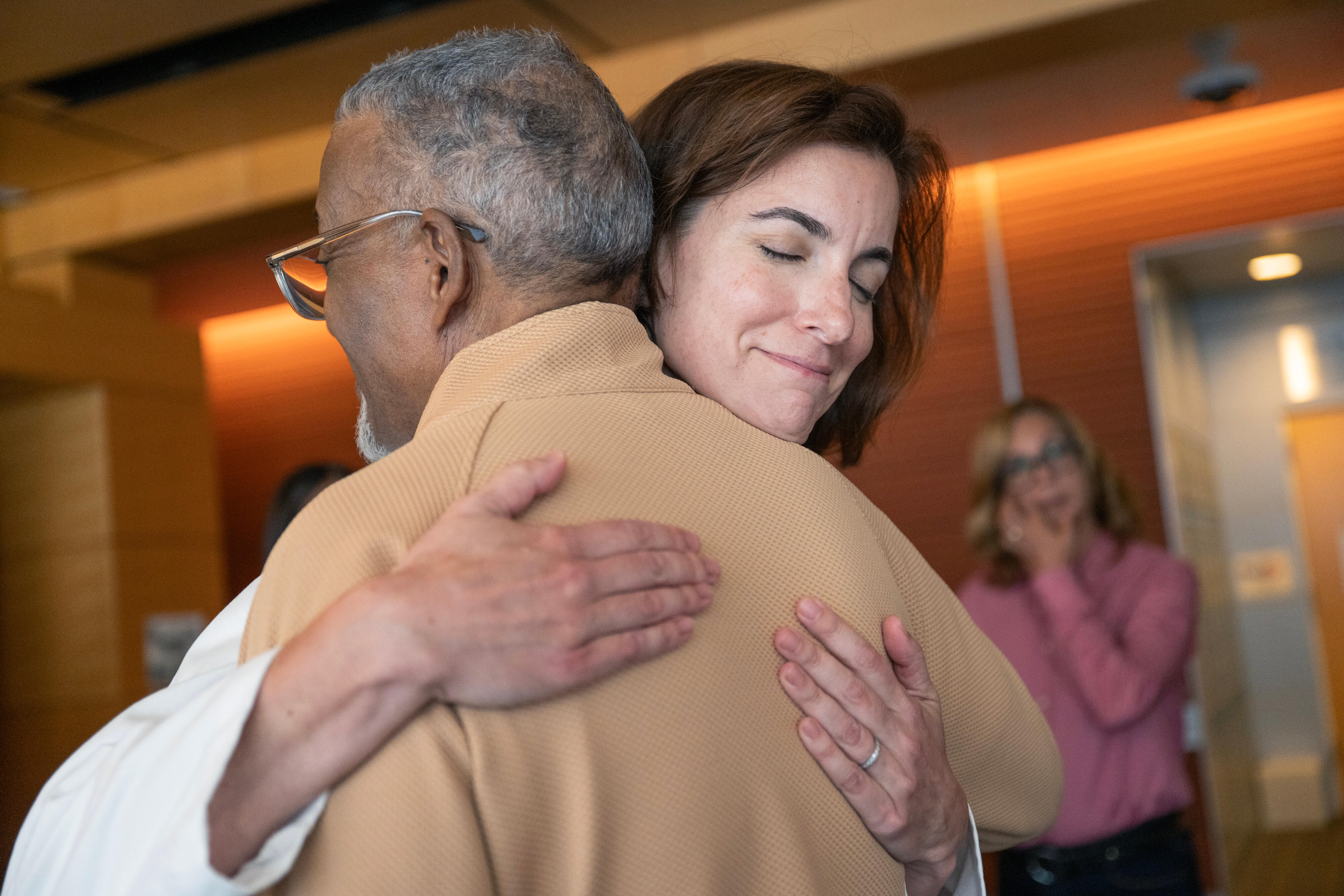 Doctor hugging patient