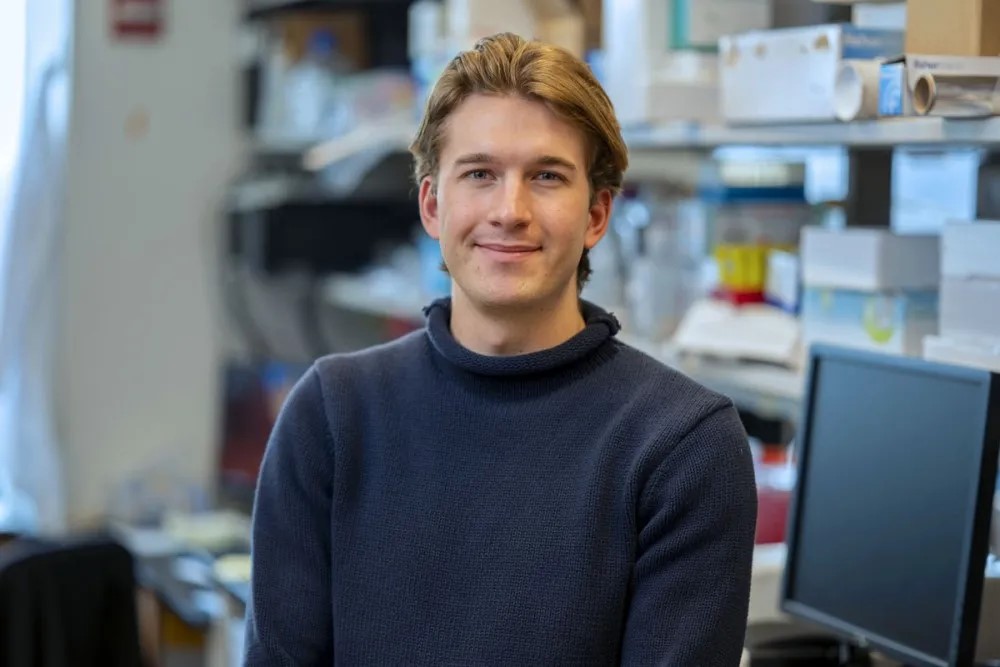 PHD student Dana Goerzen stands in the Heller Lab smiling