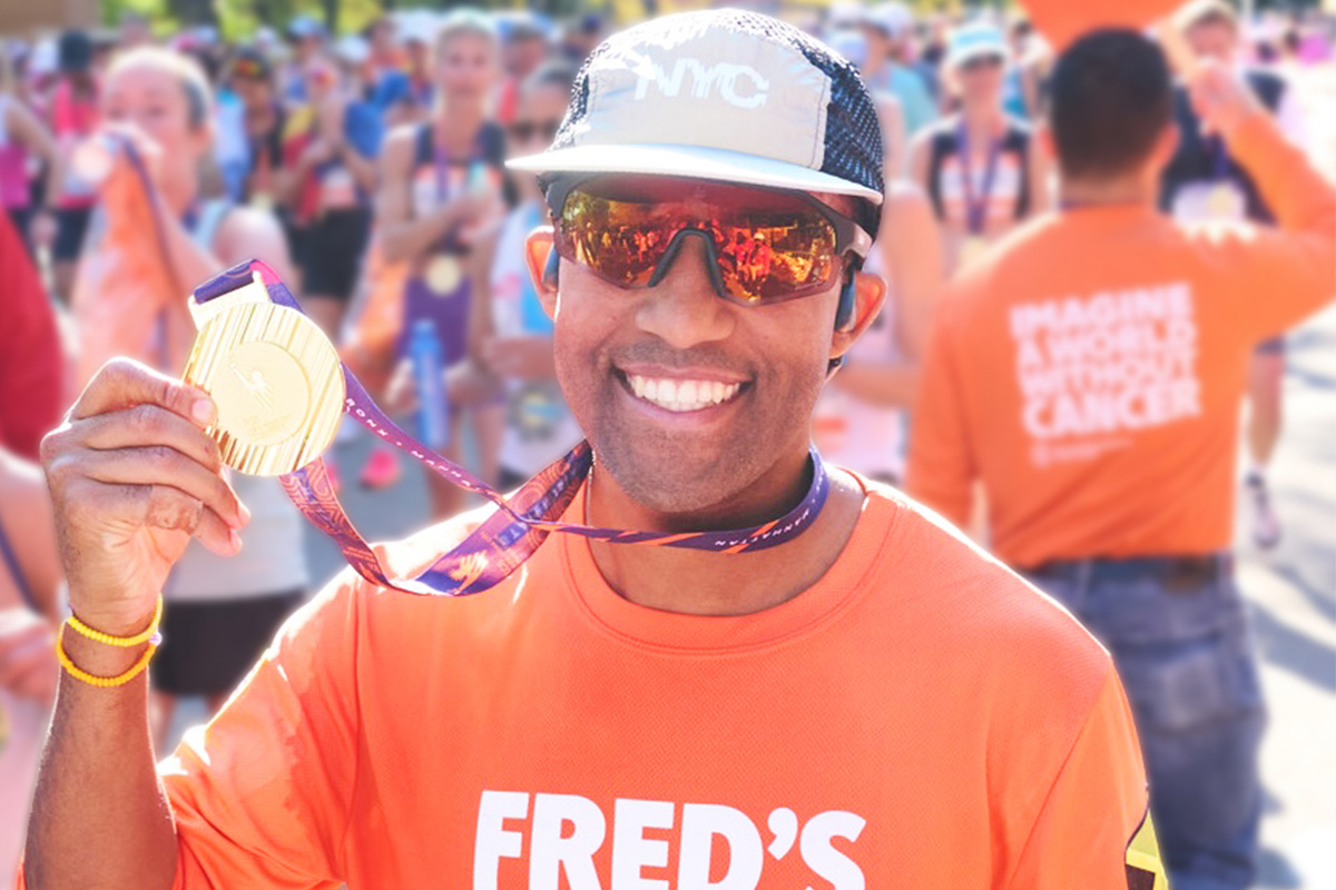 runner holding up medal