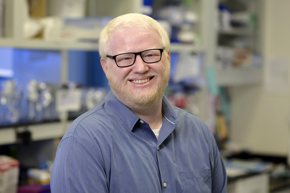 GSK alum Dr. Robert Bowman is seen smiling in a research lab