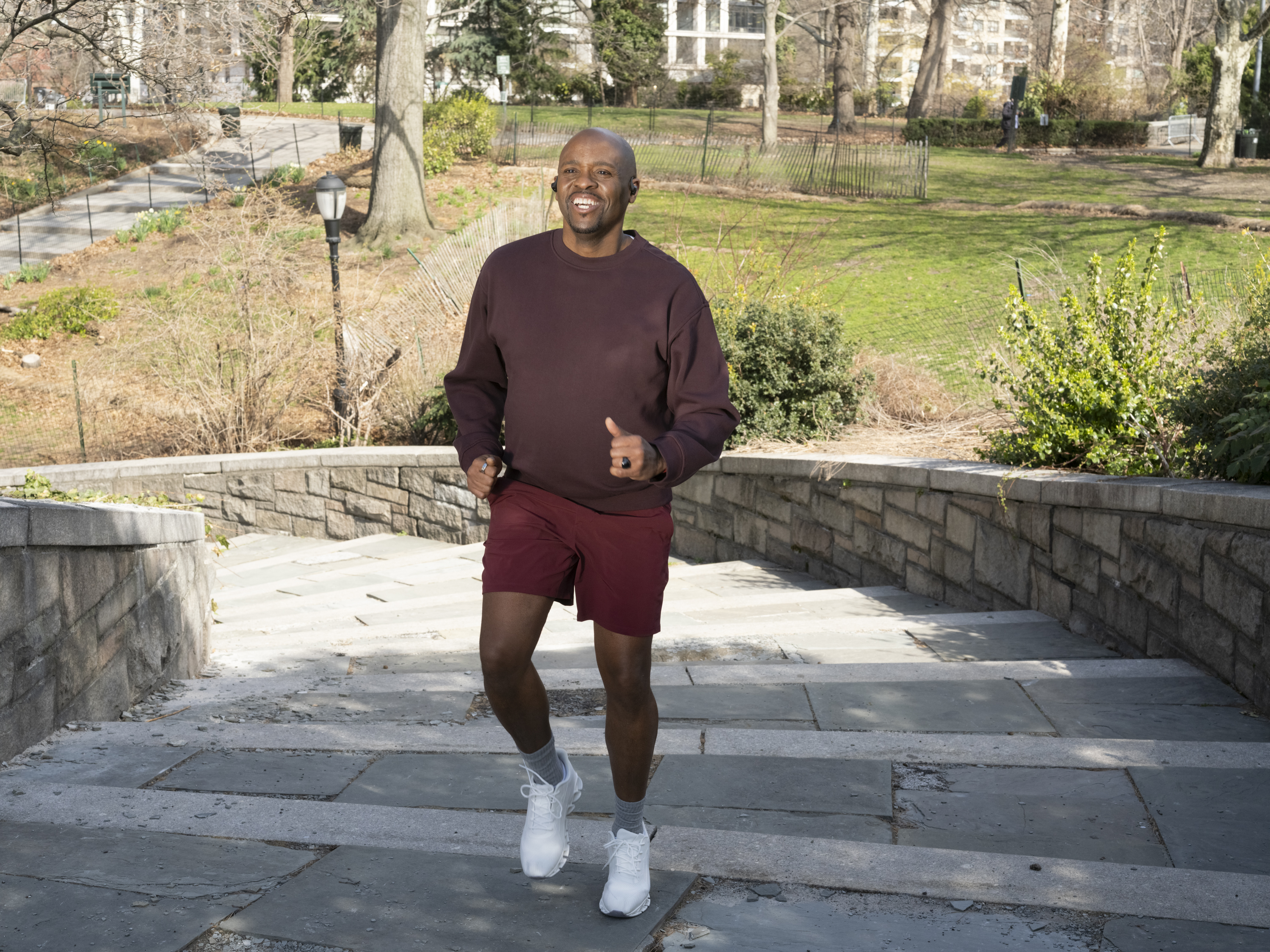 Black male jogging and smiling.