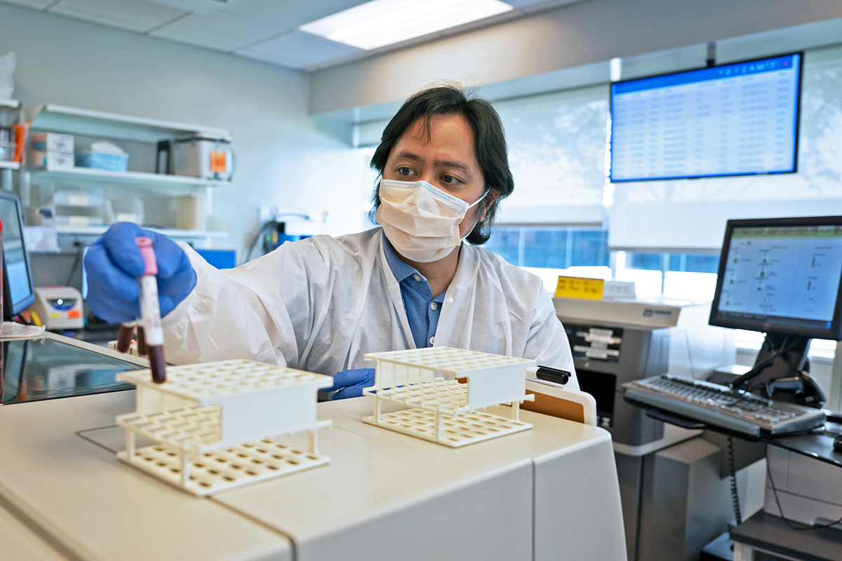 Christopher Red, a laboratory technologist, is shown working in a lab at MSK Monmouth.