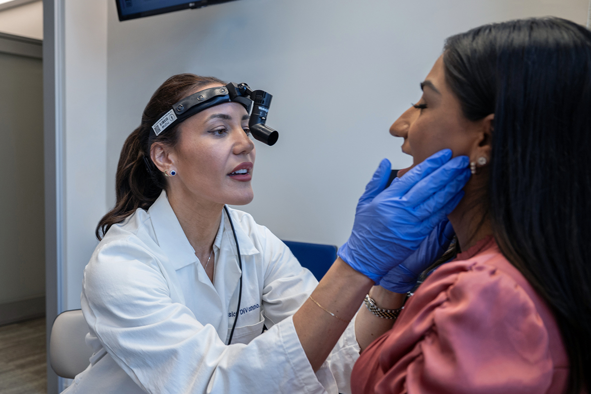 Nurse practitioner Jessica DiVanno examines a patient 