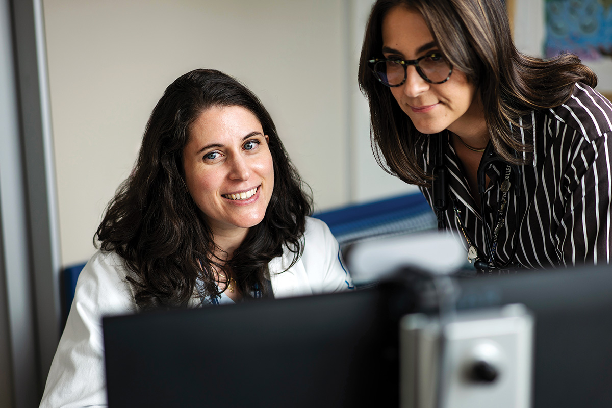MSK lymphoma oncologist Paola Ghione and nurse practitioner sitting before computer monitor.