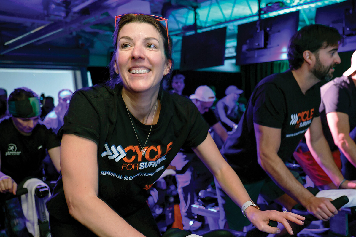 Woman on stationary bike during fundraiser.