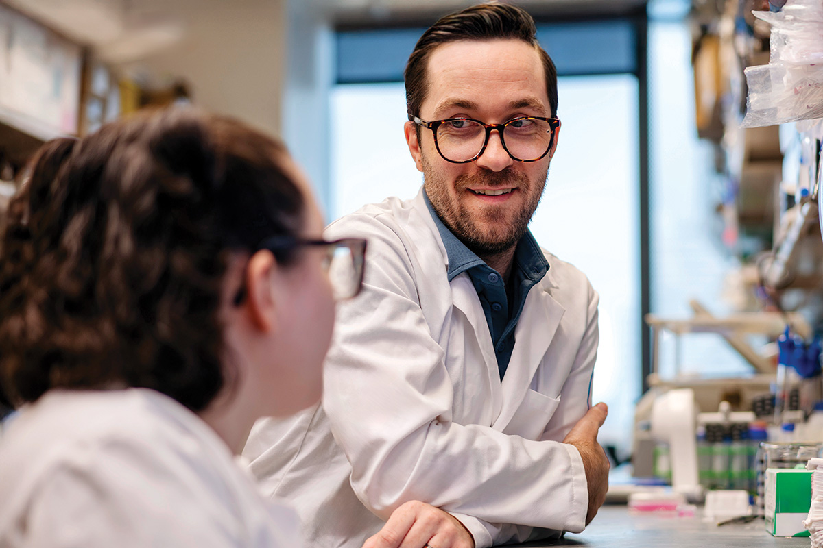 Immunologist Justin Perry talking to lab member Ana Codo.