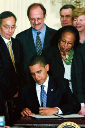 Memorial Sloan Kettering President Harold Varmus (center, in blue shirt) joined Cabinet members, members of Congress, and other stem cell research advocates to witness President Barack Obama signing an Executive Order lifting the government's ban on federal funding for stem cell research at a White House ceremony on March 9.