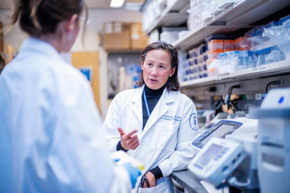 Dr. Katharine Hsu converses with a colleague.