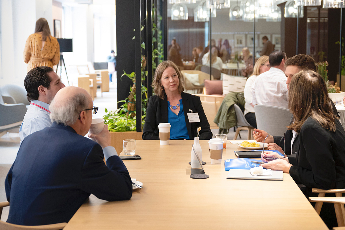 Male and female office workers having discussion in office or event environment