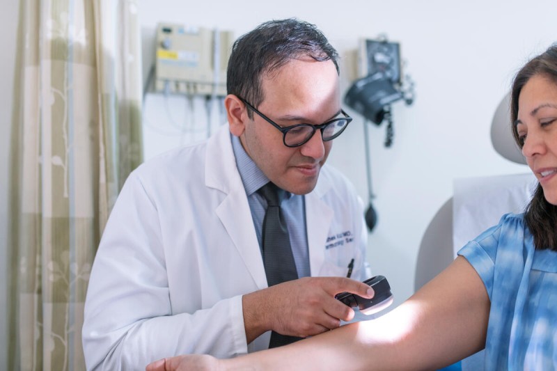 Dr. Rashek Kazi examines a patient