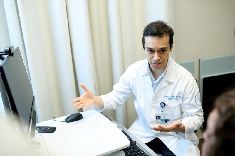 Aaron D. Goldberg, MD, PhD with a patient.