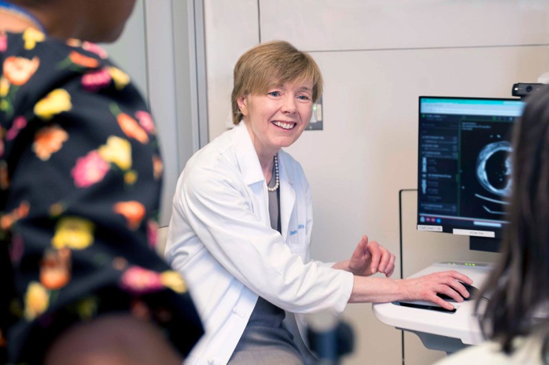 Dr. O'Reilly is showing her patient an image on a monitor in an MSK exam room.
