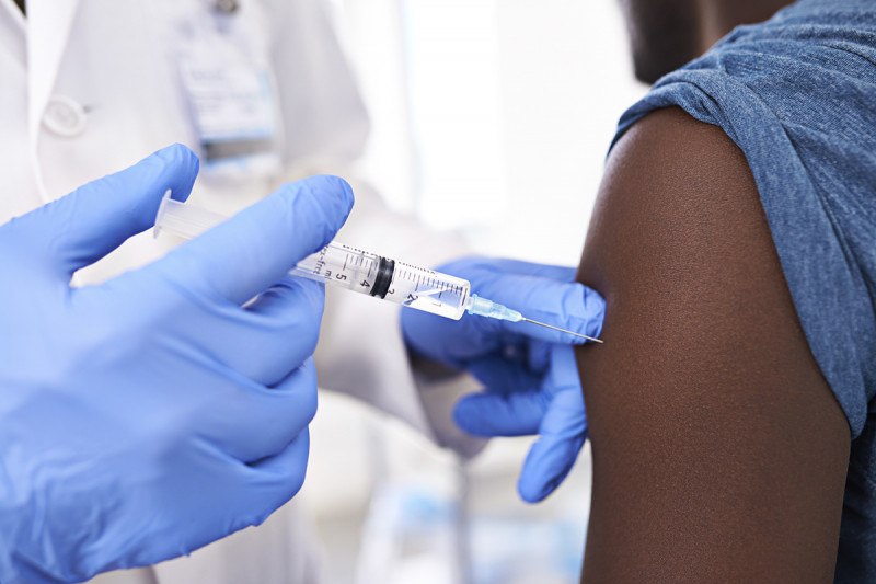 A person gets a flu vaccine injected into the arm.