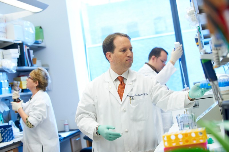 Gynecologic oncologist Douglas Levine in his lab .