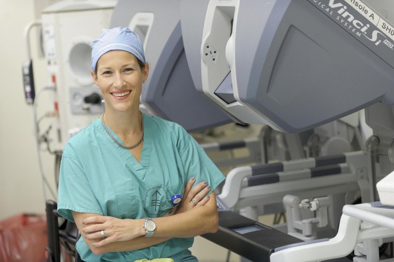 Gynecologic surgeon Elizabeth Jewell stands in front of medical equipment meant to treat gestational trophoblastic disease.