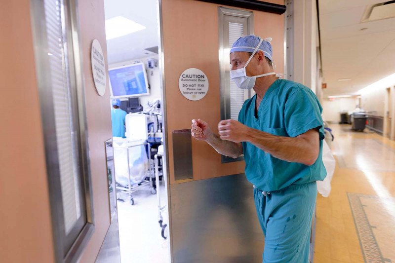 Surgeon Martin Weiser walks into operating room