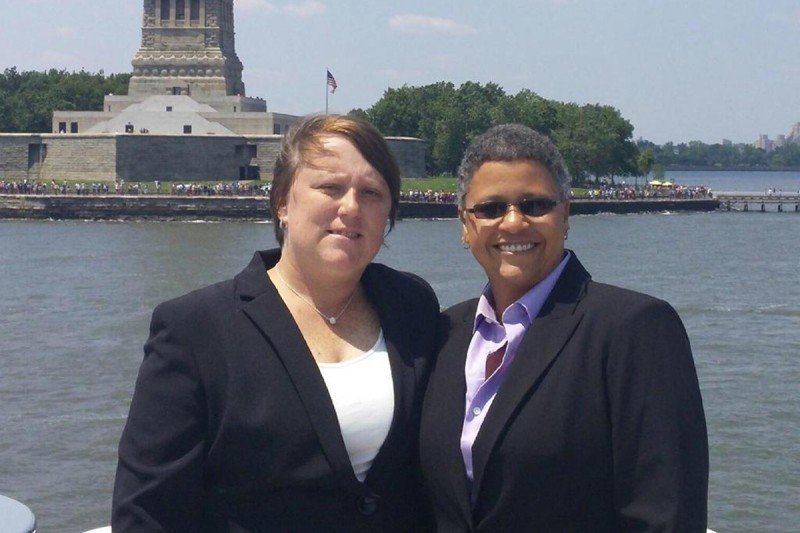 Memorial Sloan Kettering ovarian cancer patient Vilma Rosario and her partner, Michele Freeman, pose at the Statue of Liberty.