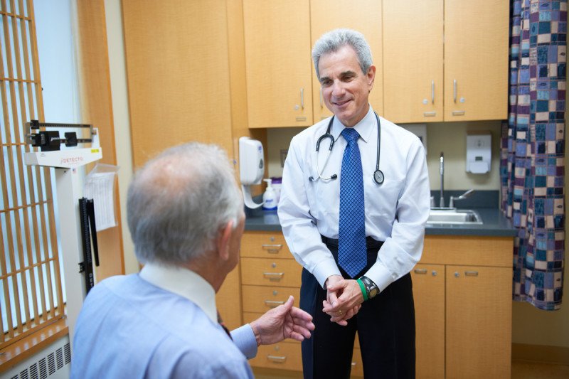 A doctor speaks with a patient who has advanced prostate cancer about inherited mutations.