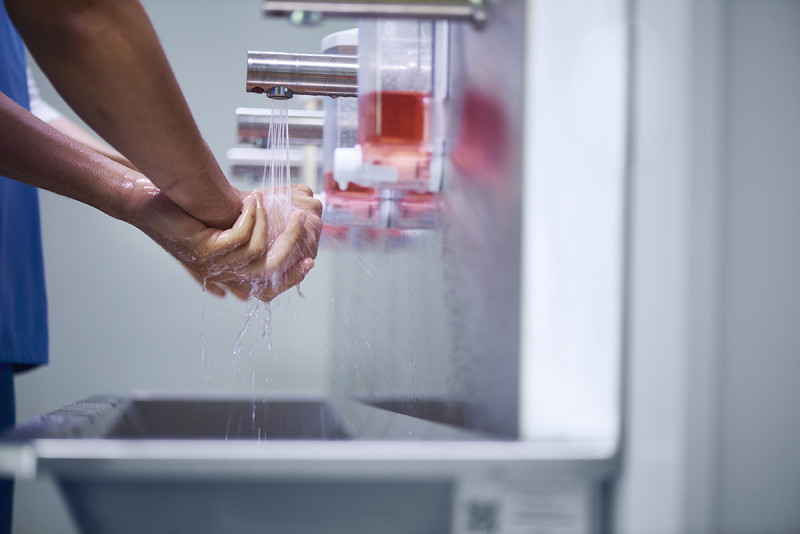 Soapy hands under a faucet