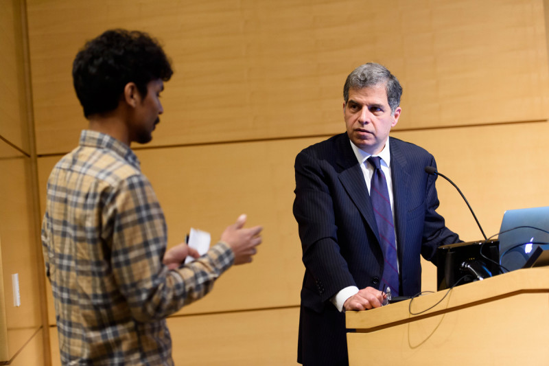 GSK student, Nayan Jain, speaks with a symposium presenter, Dr. Gary Schwartz. 