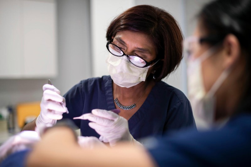 Dermatologist Dr. Kishwer S. Nehal performs a dermatologic procedure on patient