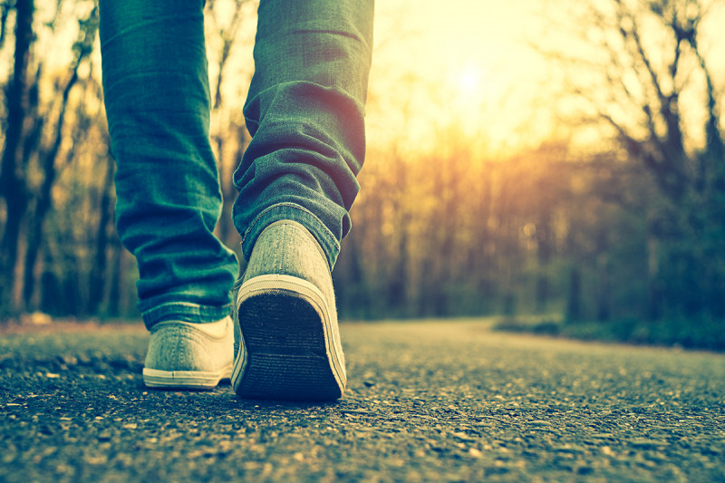 Close-up photo of someone walking on the road