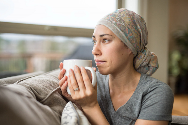 Young female cancer patient holding a tea cup