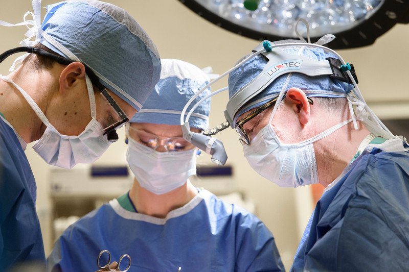 MSK throat cancer surgeon, Ian Ganly, operating with two fellow surgeons.