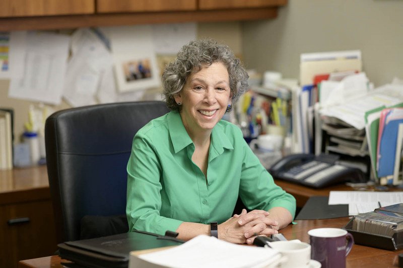 Laura Ostrowsky sitting at desk