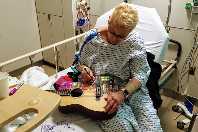 A patient doodles on a guitar