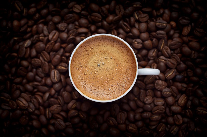 coffee cup surrounded by beans