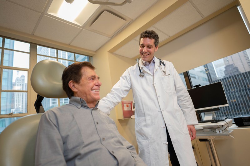 Melanoma specialist Michael Postow with a patient