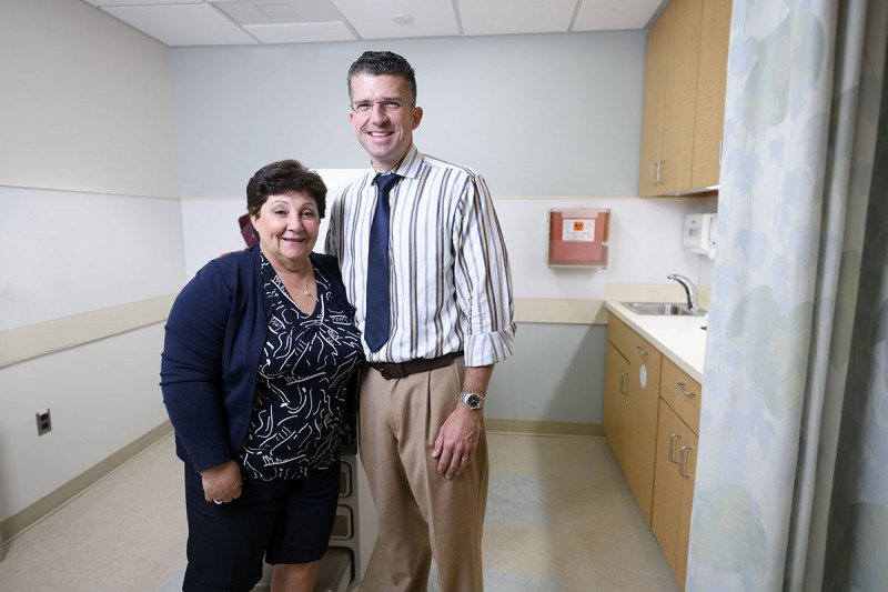 Melanoma specialist Christopher Barker hugging a patient